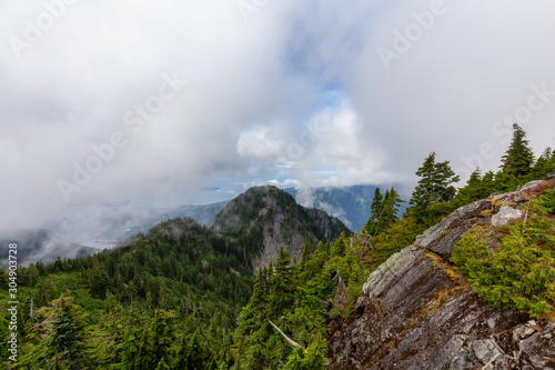 Beautiful View of Canadian Mountain Landscape during a cloudy summer morning. Taken on Crown Mountain, North Vancouver, British Columbia, Canada.