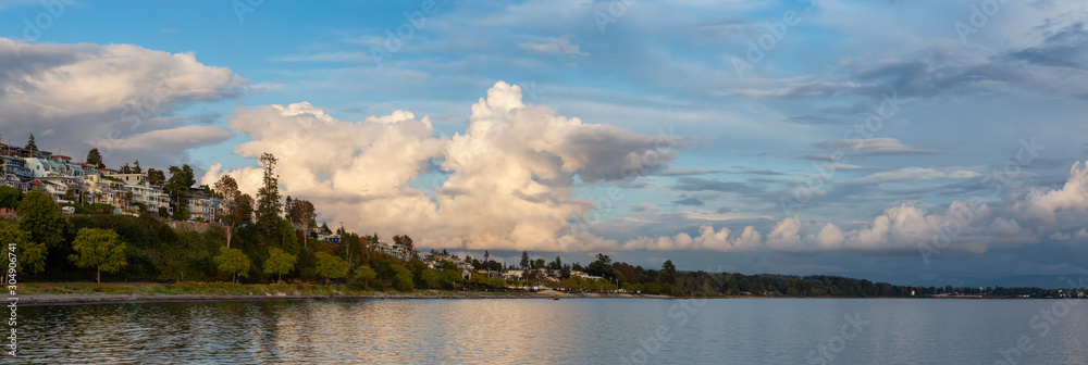 White Rock, British Columbia, Canada. Beautiful Panoramic View of Residential Homes on the Ocean Shore during a sunny and cloudy summer sunset.