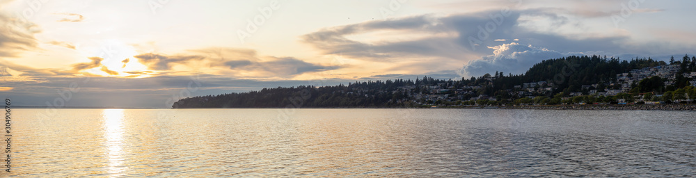White Rock, British Columbia, Canada. Beautiful Panoramic View of Residential Homes on the Ocean Shore during a sunny and cloudy summer sunset.