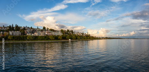 White Rock, British Columbia, Canada. Beautiful Panoramic View of Residential Homes on the Ocean Shore during a sunny and cloudy summer sunset.