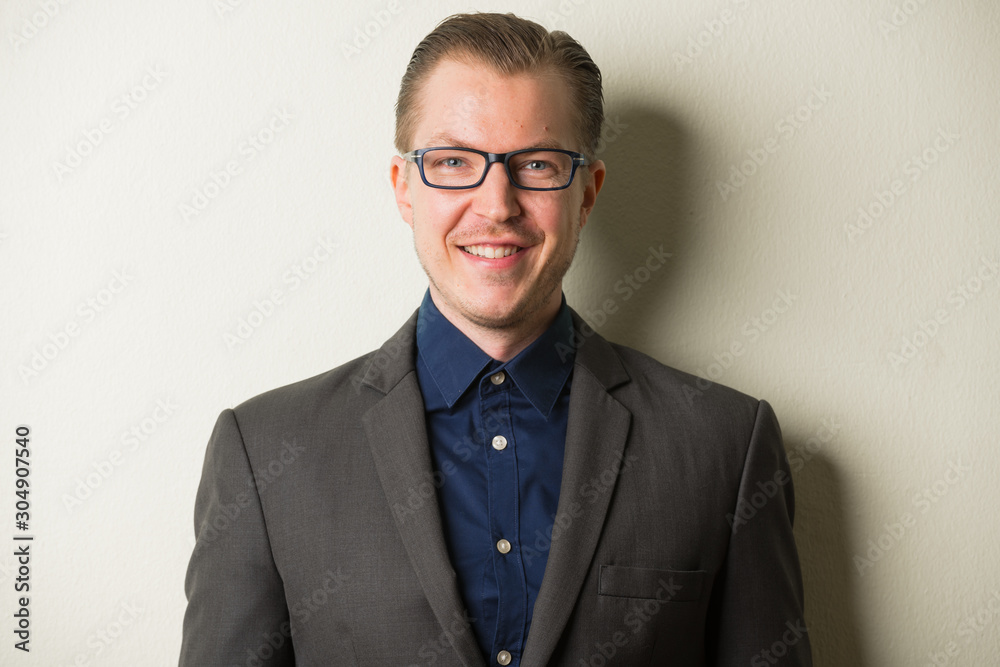© Ranta Images - Face of happy young handsome businessman with eyeglasses smiling