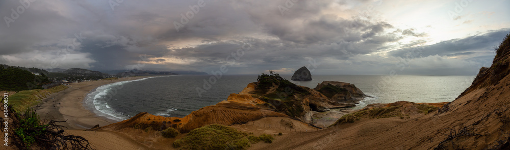 Fototapeta premium Cape Kiwanda, Pacific City, Oregon Coast, United States of America. Beautiful Panoramic Landscape View of a Sandy Shore on the Ocean during a cloudy summer sunset.