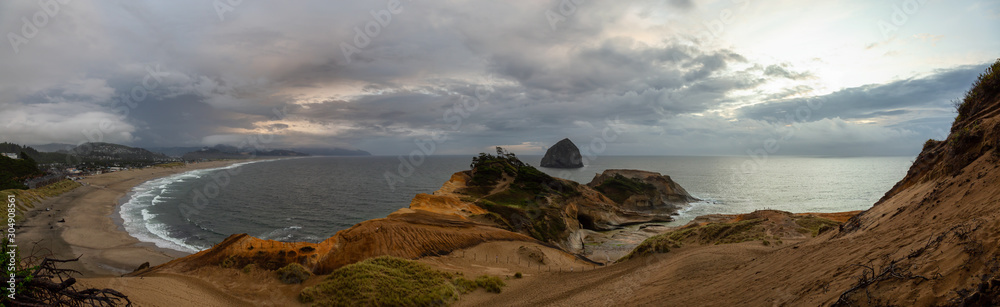 Cape Kiwanda, Pacific City, Oregon Coast, United States of America. Beautiful Panoramic Landscape View of a Sandy Shore on the Ocean during a cloudy summer sunset.