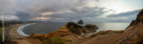 Cape Kiwanda, Pacific City, Oregon Coast, United States of America. Beautiful Panoramic Landscape View of a Sandy Shore on the Ocean during a cloudy summer sunset.