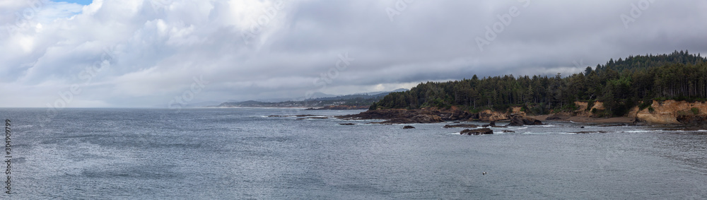 Beautiful Panoramic View of Lincoln Beach on the Pacific Ocean Coast during a cloudy summer day. Taken in Boiler Bay State Scenic Viewpoint, Oregon, United States.