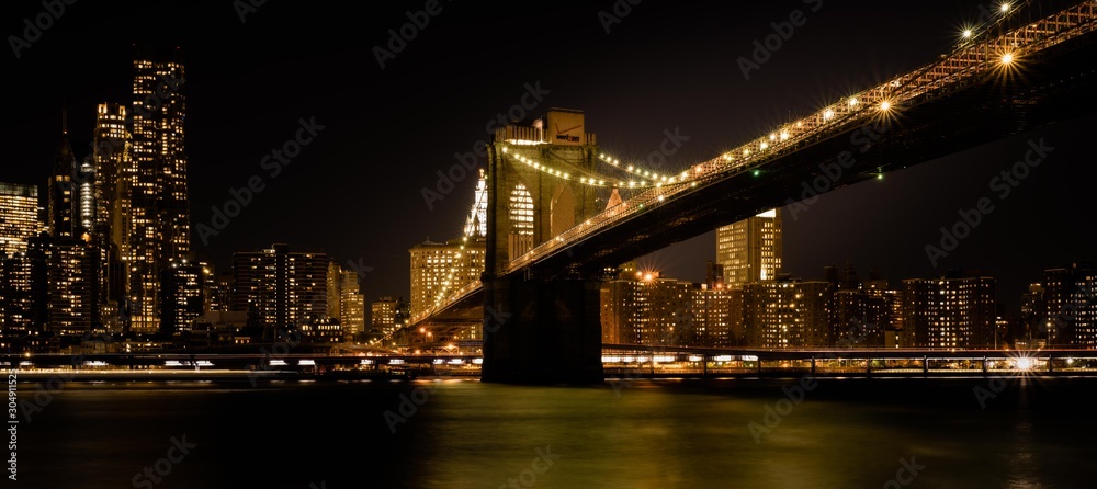 brooklyn bridge night lights buildings sea reflection