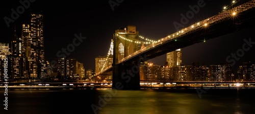 brooklyn bridge night lights buildings sea reflection