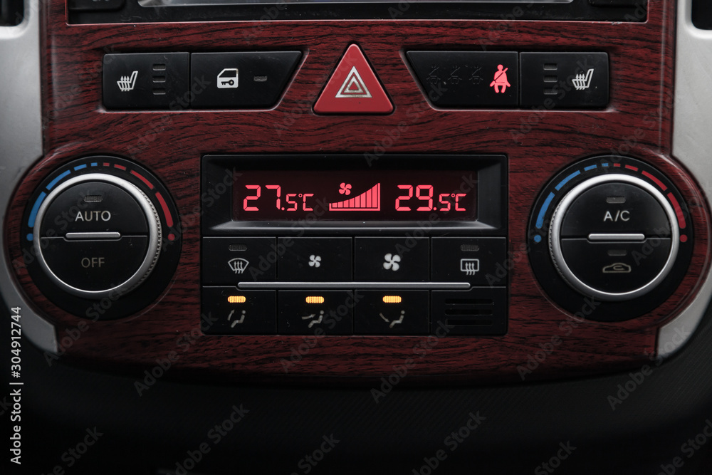 Control buttons for the climate control car with automatic control, the display on which shows the temperature in degrees Celsius with the number 18 and the buttons to zoom and reduce Control buttons for the climate control car with automatic control, the display on which shows the temperature in degrees Celsius with the number 18 and the buttons to zoom and reduce