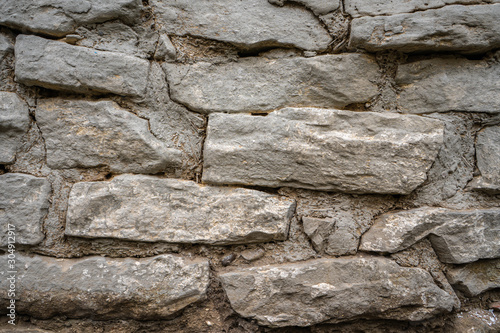 Background of an old wall of stone and clay with straw