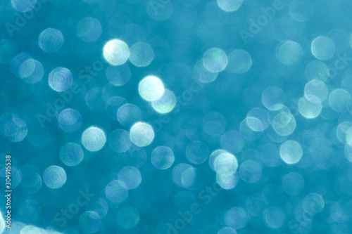 blue Sparkling Lights Festive background with texture. Abstract Christmas twinkled bright bokeh defocused and Falling stars. Winter Card or invitation	