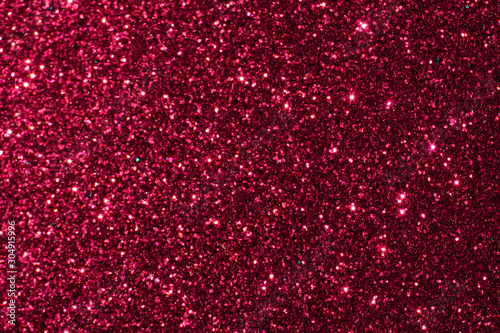 red Sparkling Lights Festive background with texture. Abstract Christmas twinkled bright bokeh defocused and Falling stars. Winter Card or invitation	