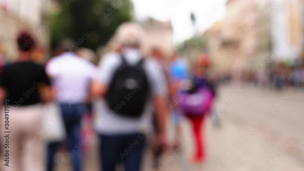 Blured people walking around the square in a beautiful European city. Pedestrians walk in sunny day. Out of focus background 1080p video Blured people walking around the square in a beautiful European city. Pedestrians walk in sunny day. Out of focus background 1080p video