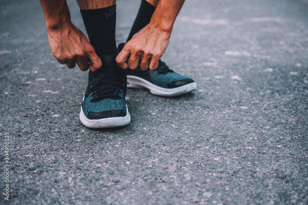 Close up Runner Man are trying Running Shoes for run jogging exercise