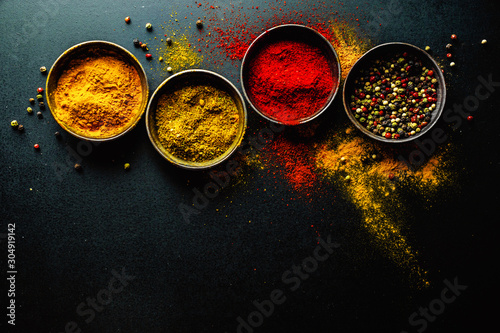 Fototapeta Naklejka Na Ścianę i Meble -  Colorful spices on dark background