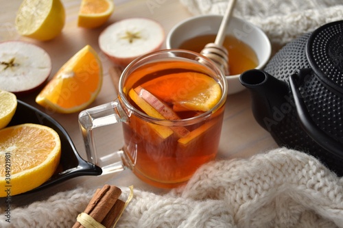 Hot healthy warming winter tea with apple, orange, lemon, honey and cinnamon.