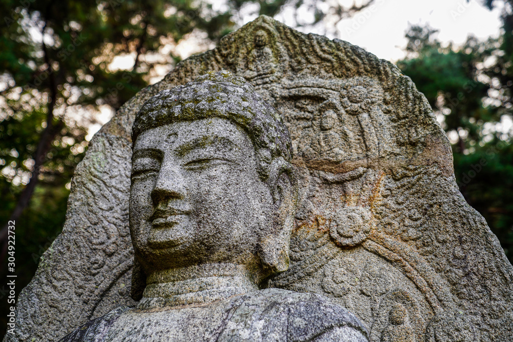 A face of the historic Buddha stone statue A face of the historic Buddha stone statue
