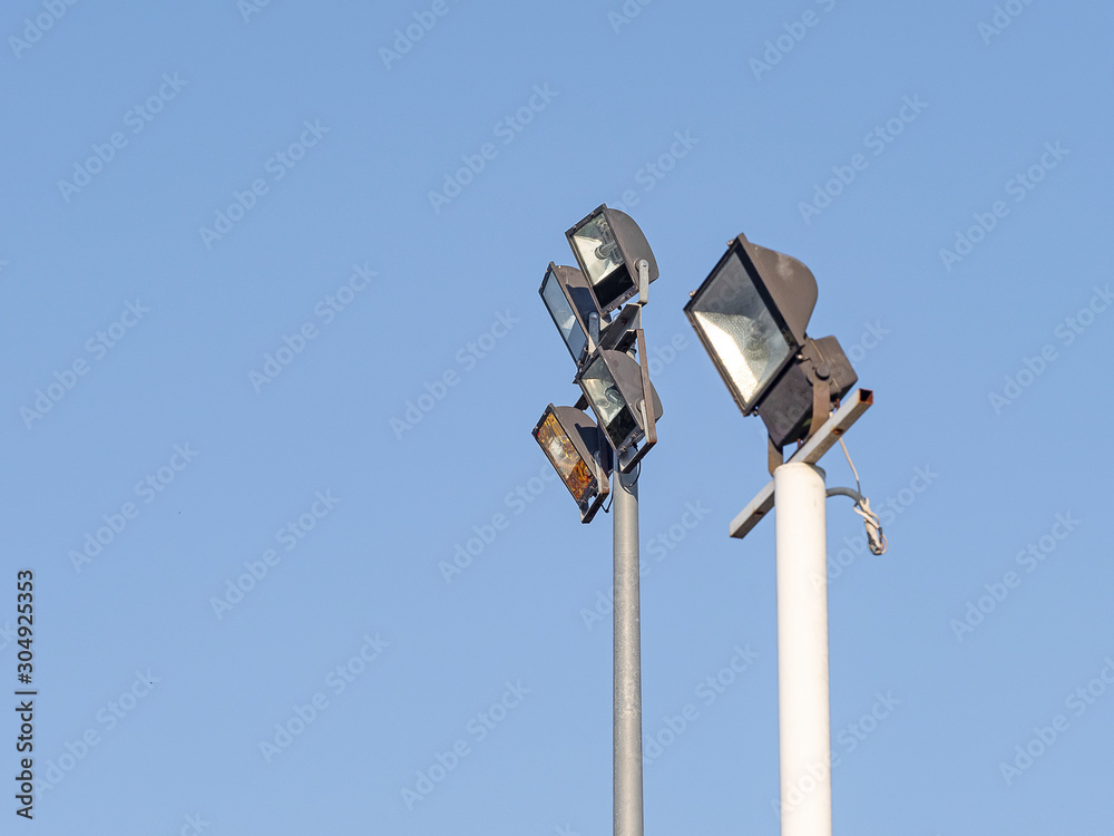 Spotlight for outdoor square shape 4 piece made with steel stick on the pole steel have blue sky background. Spotlight for outdoor square shape 4 piece made with steel stick on the pole steel have blue sky background.
