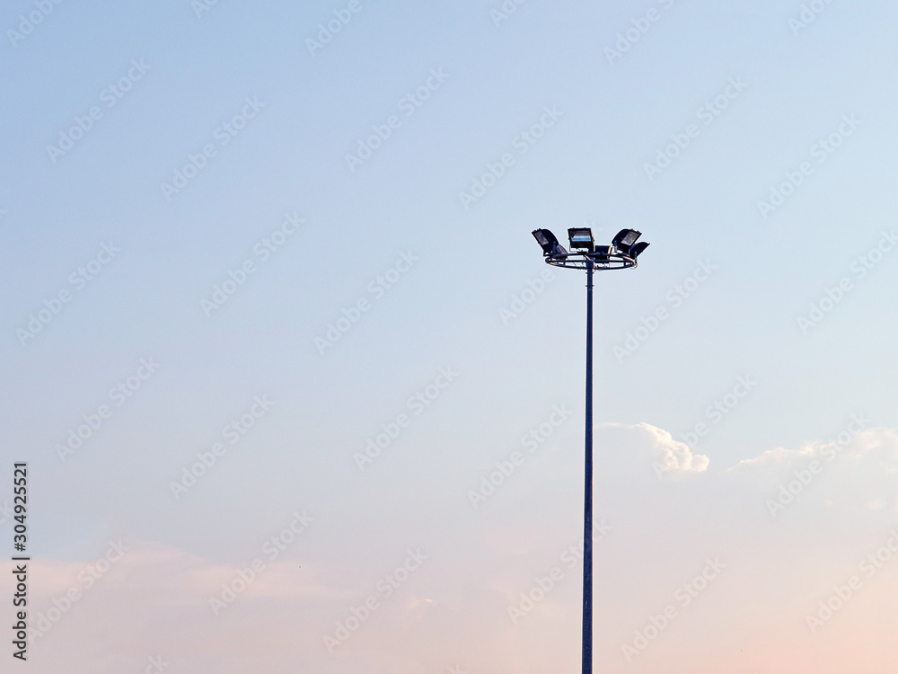 Spotlight for outdoor square shape 4 piece made with steel stick on the pole steel have blue sky background.