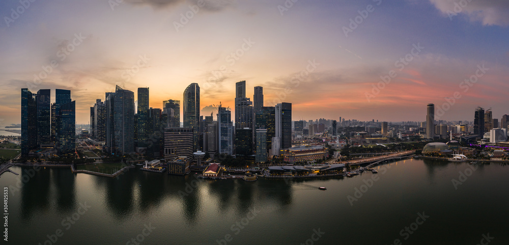 Stunning sunset over the famous Singapore skyline by the Marina in Southeast Asia main financial center