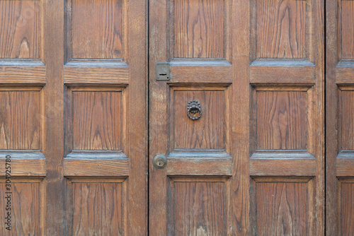 Wooden door background with iron door knocker