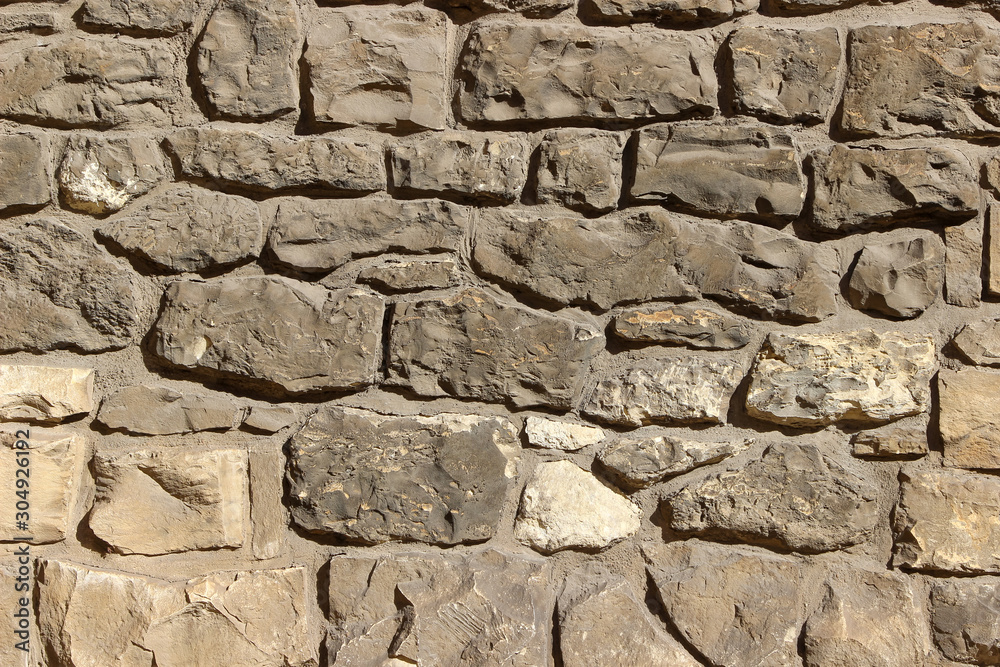 Ancient wall made of natural rocks and cement Ancient wall made of natural rocks and cement