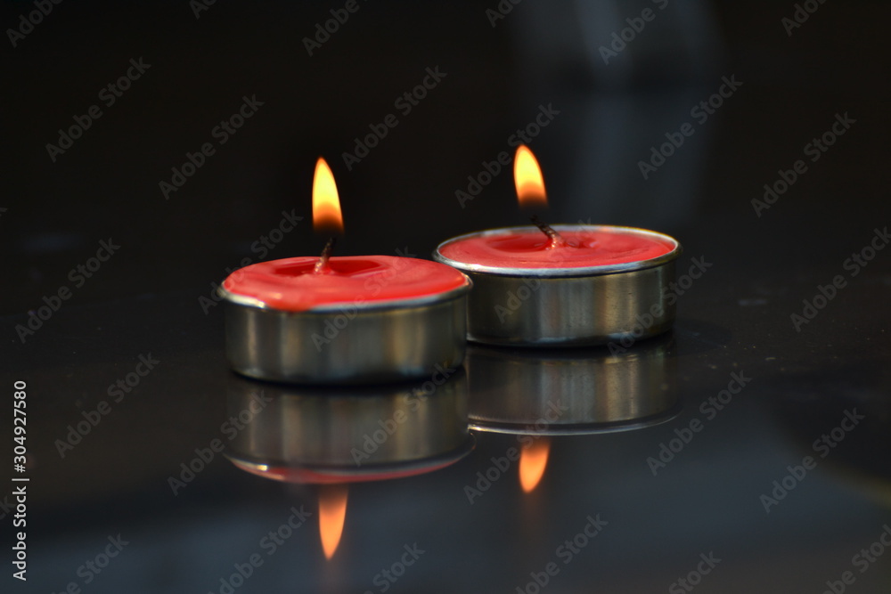 Red candle on a black background. Red candle on a black background.