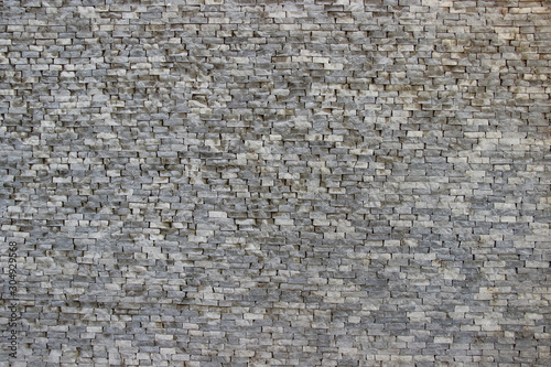 Texture of an old damaged wall made of rectangular blocks