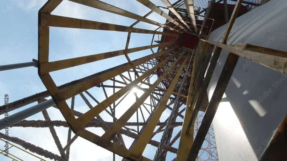 Climbing up the rig crane from the ladder. This crane is used for a ...