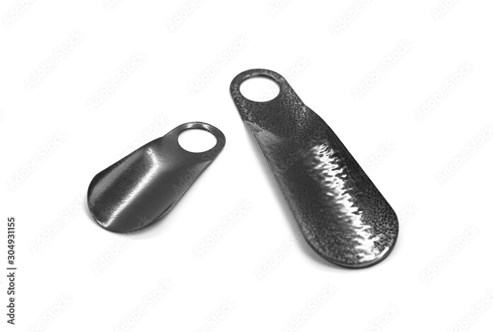 Two horns for putting on shoes. Close up. Isolated on white background Two horns for putting on shoes. Close up. Isolated on white background