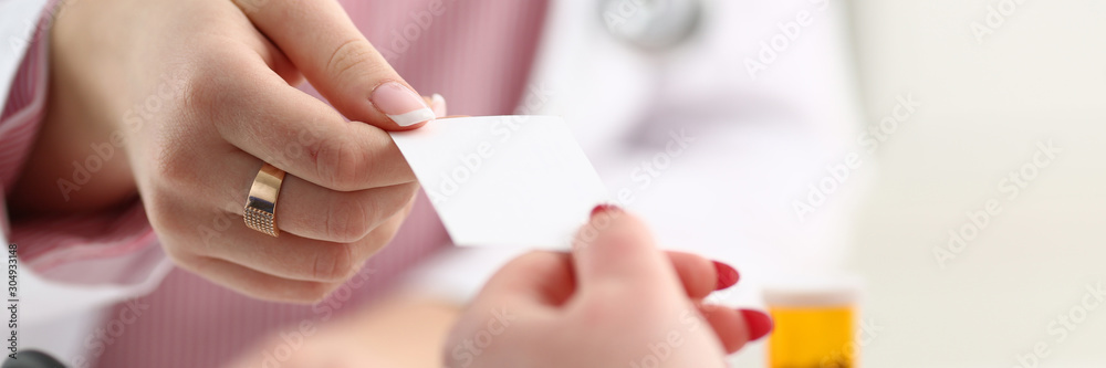 Female physician hand give white blank Female physician hand give white blank