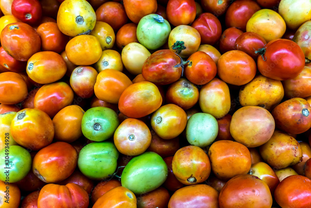 Close up Background of Fresh colorful Tomato and No pesticide residue in The organic market. Close up Background of Fresh colorful Tomato and No pesticide residue in The organic market.