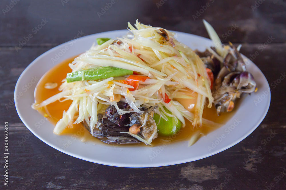 Closeup to Famous Thai food, papaya salad or SOM TAM or Somtum. in white plate. Closeup to Famous Thai food, papaya salad or SOM TAM or Somtum. in white plate.