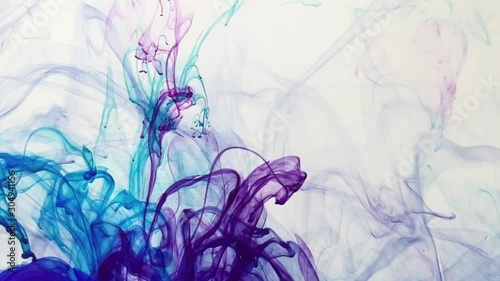 Amazing mix of blue and violet watercolor ink on a white background. Smooth slow motion of paints in water. Abstract ink background. photo