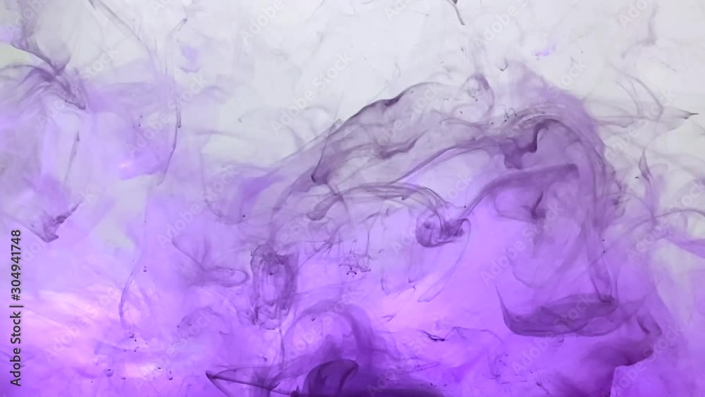 Light purple watercolor ink on a white background. Lilac smoke. The smooth movement of paints in water. Abstract ink background. Light purple watercolor ink on a white background. Lilac smoke. The smooth movement of paints in water. Abstract ink background.