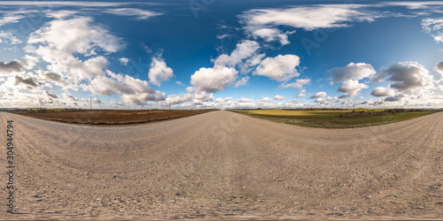 blue sky with rain storm fluffy clouds. full seamless eamless hdri panorama 360 degrees angle view on gravel road with zenith in equirectangular projection, ready for VR AR virtual reality