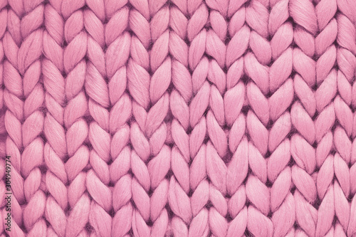 Texture of pink wool big knit blanket. Large knitting. Plaid merino wool. Top view