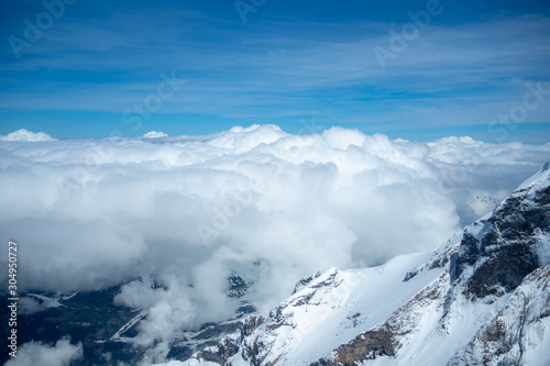 Beautiful scene of clouds and mountains looking from viewpoint at Jungfrau with blue sky for background, copy space, Switzerland