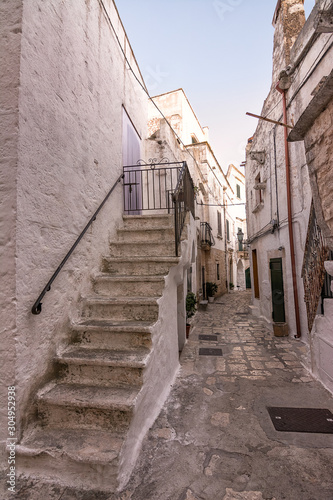 View of a typical alley with cobblestones and stairs in Ceglie Messapica (Italy)