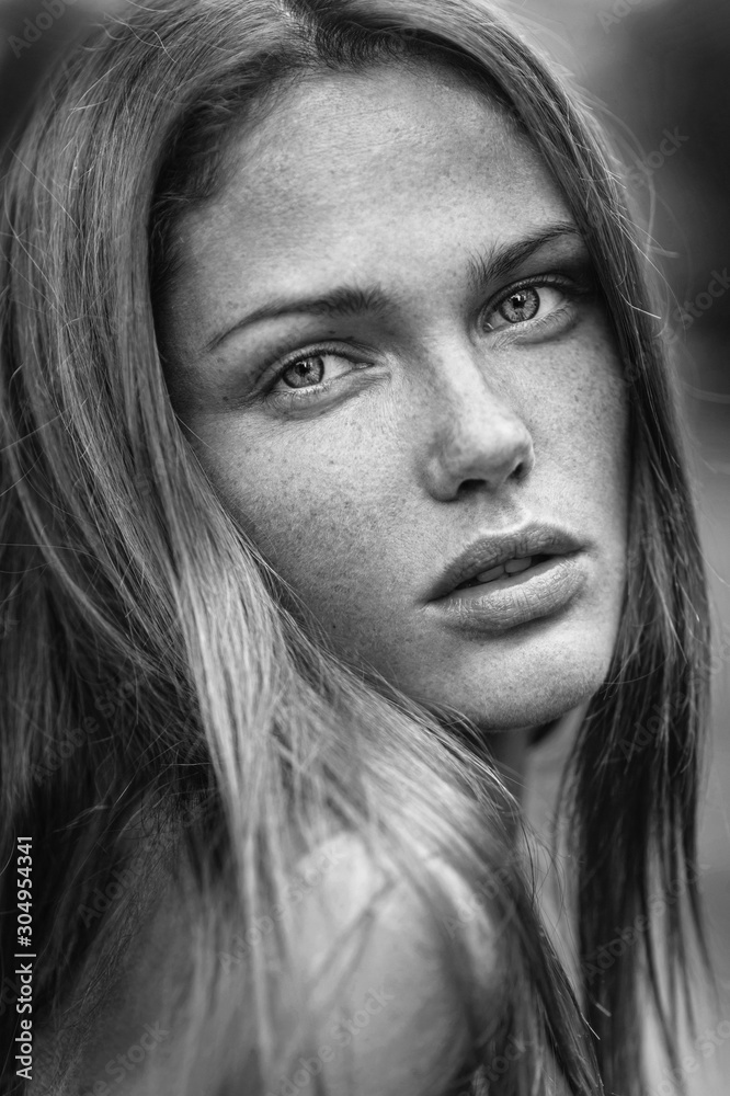 Sensual close up outdoor portrait of a caucasian girl with freckles.