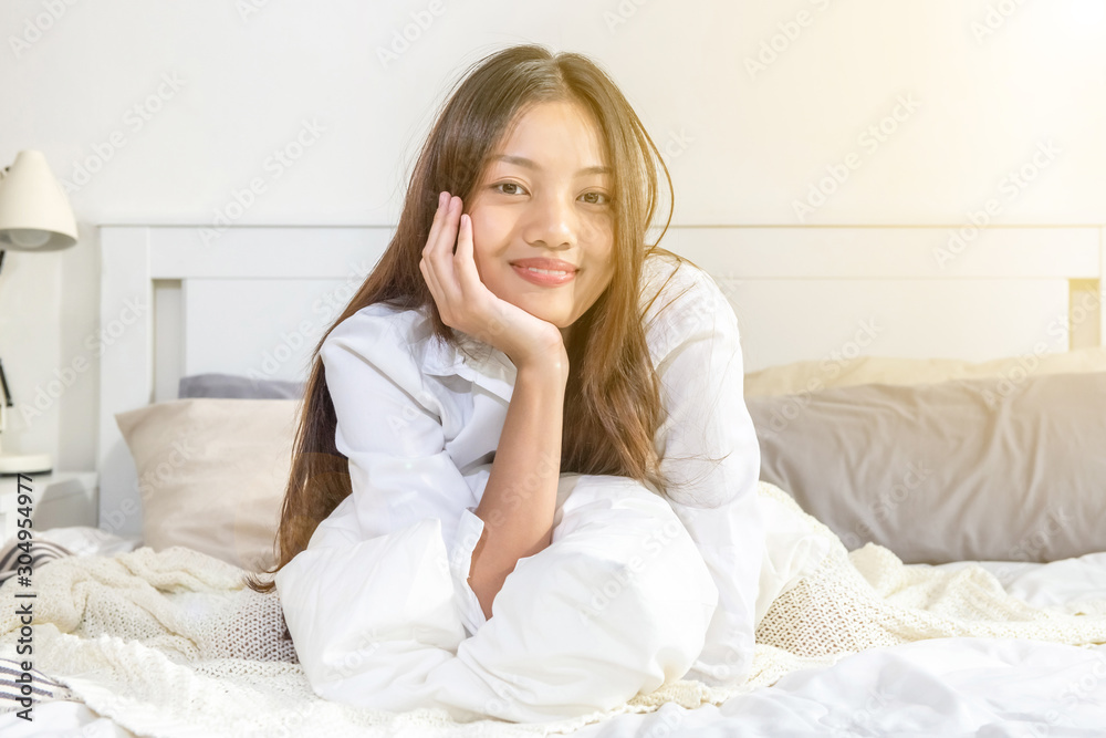 Young beautiful asian woman wake up happy in the morning. Attractive teenage girl wake up from the bed and smiling. Young beautiful asian woman wake up happy in the morning. Attractive teenage girl wake up from the bed and smiling.