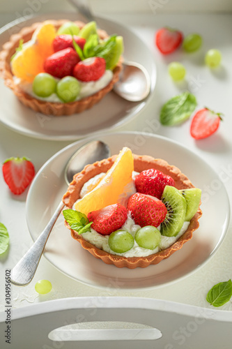 Freshly baked mini tart made of cream and fresh fruits