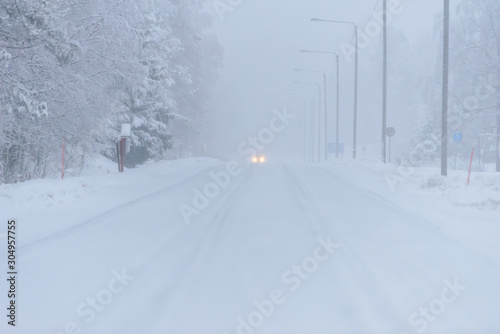 The road number 496 has covered with heavy snow and bad weather in winter season at Tuupovaara, Finland.