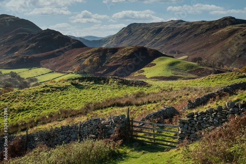 Majestic Autumn Fall landscape image of Sleet Fell and Howstead Brow in Lake District with beautiful early morning light in valleys and on hills