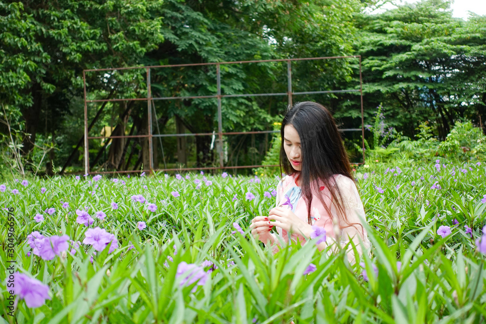 Portrait of beautiful young asian woman relaxing in garden Portrait of beautiful young asian woman relaxing in garden