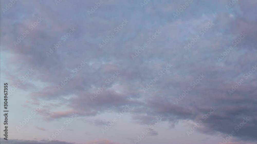 Day to night timelapse of the fast-moving clouds at sunset and blue hour. Getting dark and time passing concept. Fast sunset with fast-moving clouds