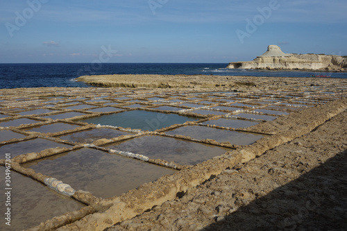 Salt pans in Xwejni, Zebbug, Gozo, Malta, longtime locale for salt production, featuring salt pans in geometric patterns by the ocean