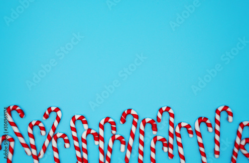 Christmas candy on pastel blue background ,New year and Christmas concept with copy space ,flatlay