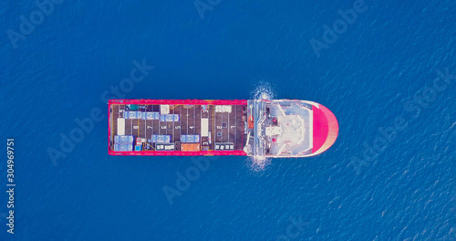 Aerial top view image of an Offshore Supply Ship in the calm ocean water.