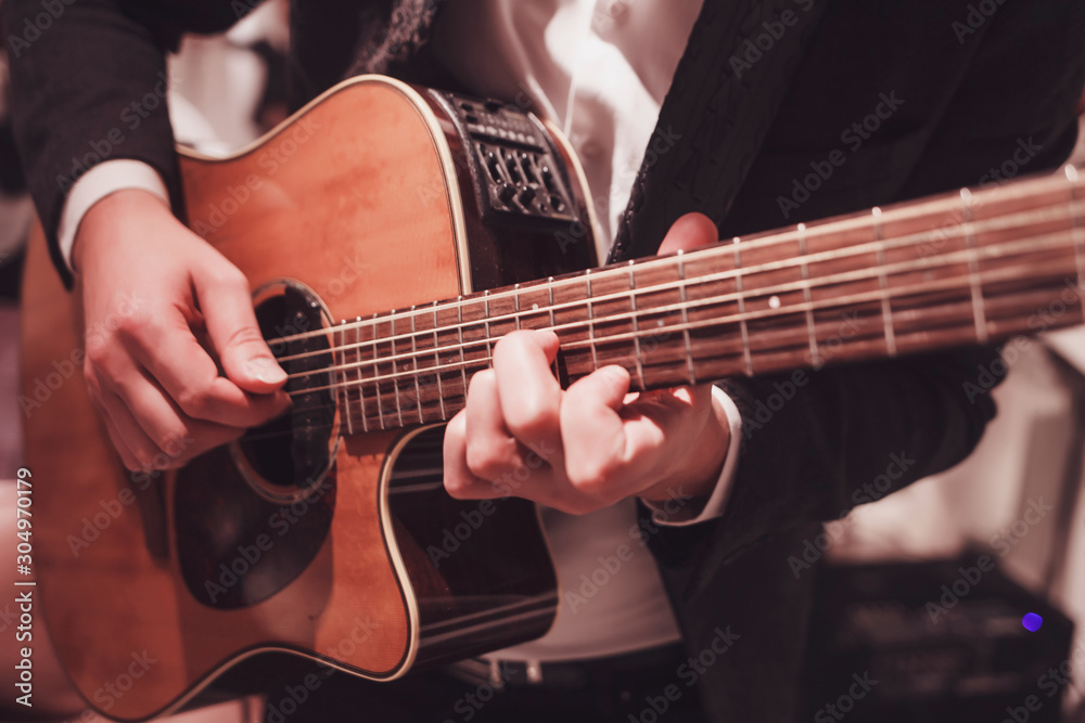 male hands playing the guitar. practice to play the instrument