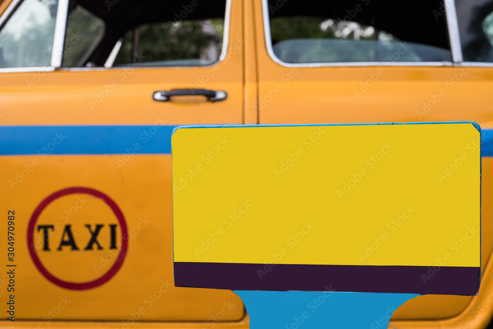 Local yellow taxi waiting for passengers in taxi stand near Victoria